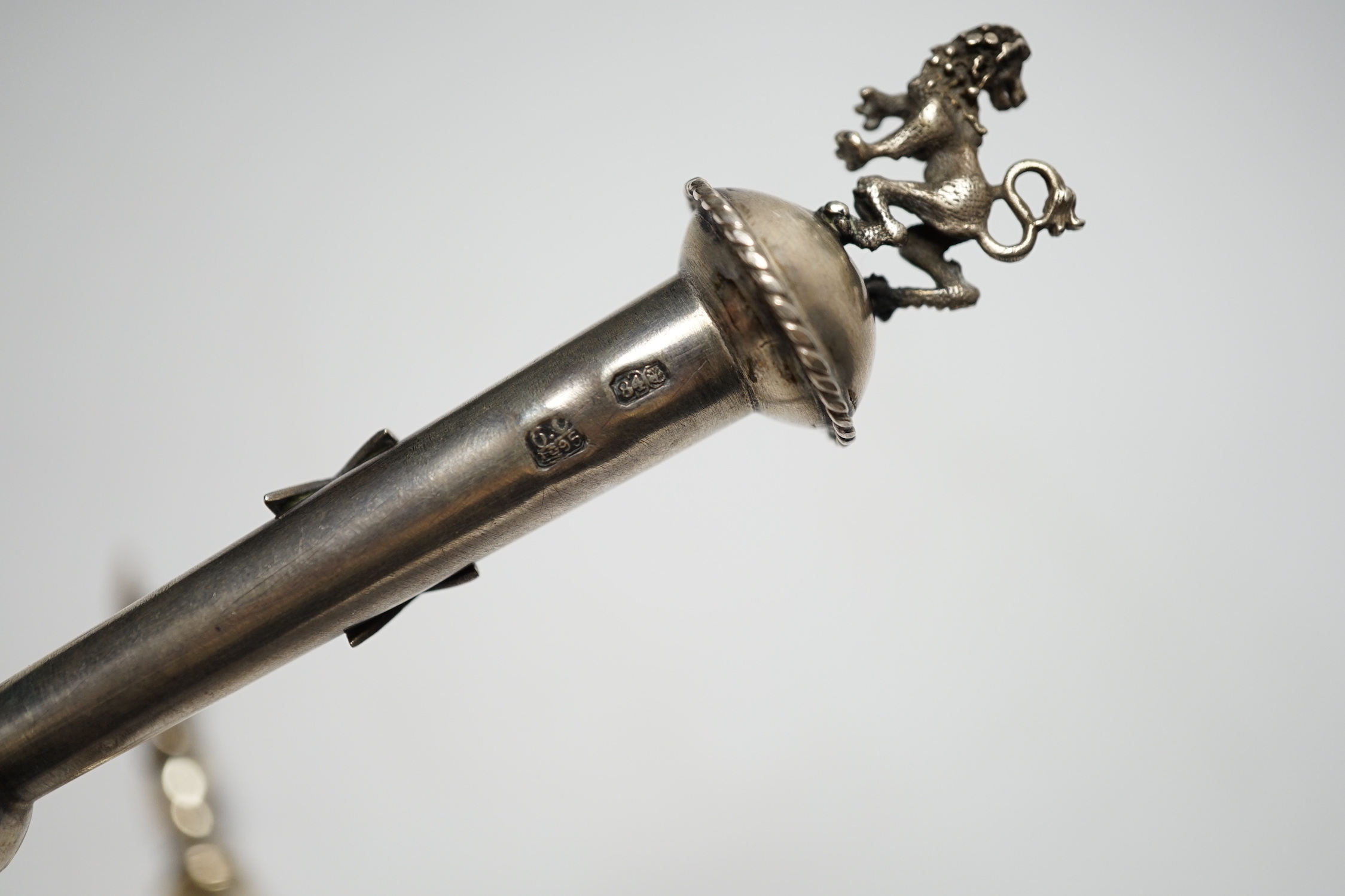 A late 19th century Russian 84 zolotnik torah pointer, with lion finial, 21.5cm and a plated example.